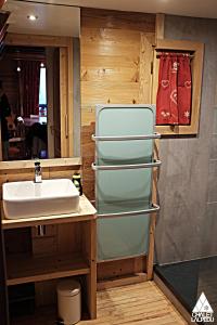 a bathroom with a sink and a refrigerator at Chalet LALPEDU in L'Alpe-d'Huez