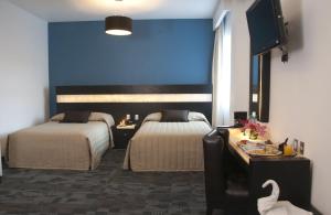Postel nebo postele na pokoji v ubytování Hotel Real Rex