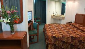 Postel nebo postele na pokoji v ubytování Hotel Real Rex