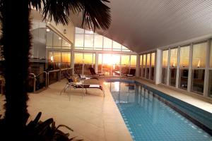 a house with a swimming pool and a building at Blue Tree Towers Caxias do Sul in Caxias do Sul