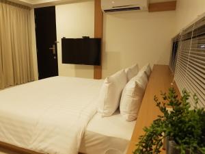 A bed or beds in a room at 8IK88 Resort - SHA Extra Plus