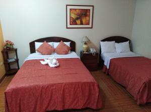 Postel nebo postele na pokoji v ubytování Hotel Suite Plaza
