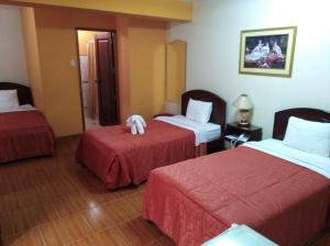 Postel nebo postele na pokoji v ubytování Hotel Suite Plaza