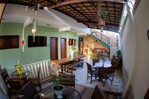 a restaurant with tables and chairs and a staircase at Pousada Lua Cheia in Aracaju