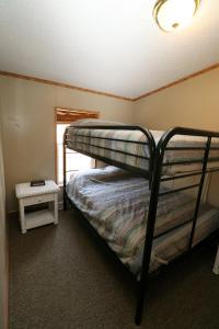 a bedroom with two bunk beds and a window at Island Club #93 in Put-in-Bay
