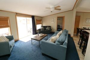 a living room with two couches and a table at Island Club #67 in Put-in-Bay