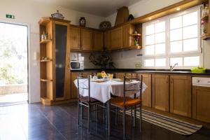 a kitchen with a table with chairs around it at Casa Nunes in Santana