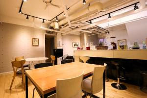 a dining room with a wooden table and chairs at Mama Guesthouse Myeongdong in Seoul