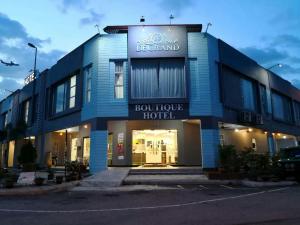 a blue building with a sign for a boutique hotel at PI Grand Hotel in Sepang