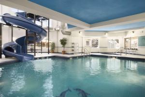 a pool with a water slide in a building at Travelodge by Wyndham Strathmore in Strathmore