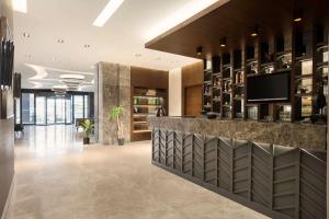 a lobby with a bar in a building at Ramada By Wyndham Nilufer Bursa in Bursa