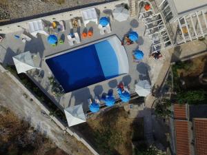 an overhead view of a swimming pool with tables and chairs at Luštica Apartments in Luštica