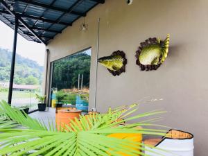 a room with two fish decorations on the wall at Hotel Nelayan in Pangkor