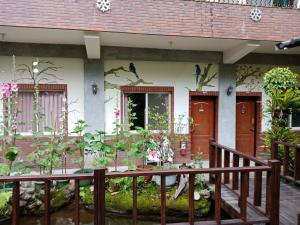 a house with a mural of birds on the side of it at Yi Jia Yuan Homestay in Nanzhuang