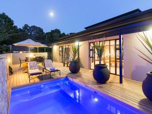 a house with a swimming pool and a patio at The Greens Guest House in Knysna