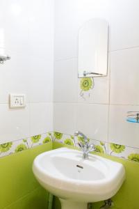 a bathroom with a sink and a mirror at Villa Emmanuel 1BHk Holiday Homes in Candolim +9 photos