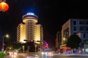 a building on a city street at night at Chambery Hotel in Zhuhai
