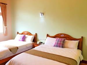 Uma cama ou camas num quarto em Jiang Shui Village B&B