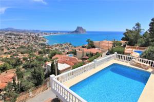 a villa with a swimming pool and a view of the ocean at A0831 in Calpe