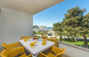 a dining room with a table and chairs and a balcony at Luxury Apartments Novigrad in Novigrad Istria