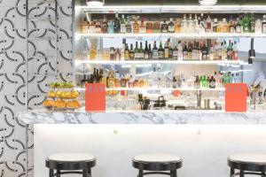 a bar with stools in front of a counter at Placid Hotel Design & Lifestyle Zurich in Zürich