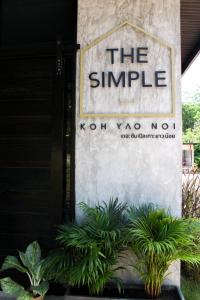 a sign for the simple north yorkno sign with plants at The Simple Koh Yao Noi in Ko Yao Noi