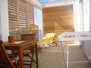 a room with a balcony with a table and chairs at Villa Lipa in Zadar
