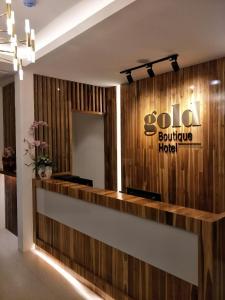 a hotel lobby with a hotel sign on the wall at Gold Boutique Hotel in Seremban