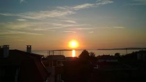 a sunset over the water with the sun in the sky at Hotel Veleka in Chernomorets