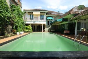 a swimming pool in front of a house at Villa Sri Manganti in Jakarta