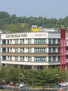 a building with a sign for a hotel at Gold Boutique Hotel in Seremban