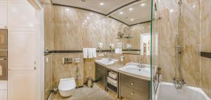 a bathroom with a toilet and a sink and a shower at VIP Residence Riverside in Budapest