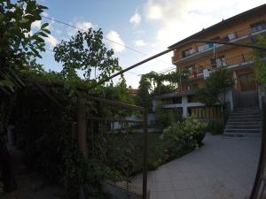 a building with a staircase next to a courtyard at Prostor Guest House in Byala
