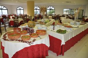 a long table with plates of food on it at Green Garden Club in Briatico