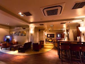a bar in a restaurant with chairs and tables at Gainsborough House Hotel in Kidderminster
