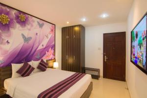 Postel nebo postele na pokoji v ubytování Ngoc Linh Luxury Hotel