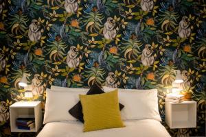 a bedroom with a bed with a floral wallpaper at Arsenale Suites in Verona