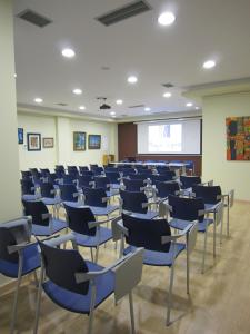 una clase con sillas azules en una habitación en Hotel Playa de Laxe, en Laxe