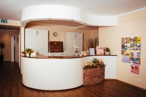 a lobby with a large white counter in a room at Hotel-Restaurant Fuchs in Handeloh