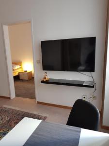 a large flat screen tv hanging on a wall at Gerald`s Apartment 10 in Vienna