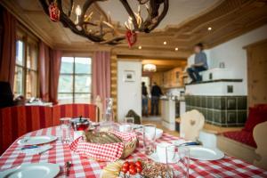 a table with a red and white checkered table cloth at Bergchalet Kuhgraben in Bad Sankt Leonhard im Lavanttal