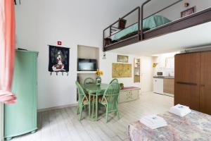 a kitchen and dining room with a table and chairs at Maqueda Apartments in Palermo