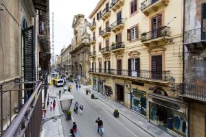 a city street with people walking down the street at Maqueda Apartments in Palermo