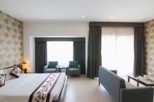 Postel nebo postele na pokoji v ubytování Ngoc Linh Luxury Hotel
