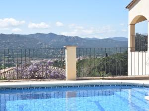 a swimming pool with a view of the mountains at Belvilla by OYO Casa El Limonero in Santa Cristina d'Aro