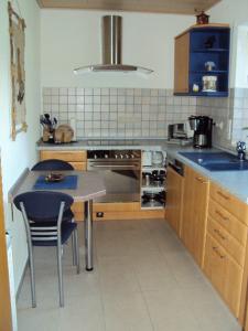 a kitchen with a table and a stove top oven at Ferienwohnung Hankel in Hemfurth-Edersee