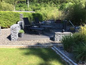 a patio with a table and chairs in a garden at Ferienwohnung Hankel in Hemfurth-Edersee +10 photos