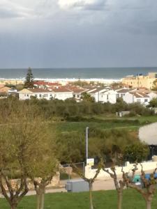 a view of a town with the ocean and houses at Casa _pareada con piscina y jardin privado in Torredembarra