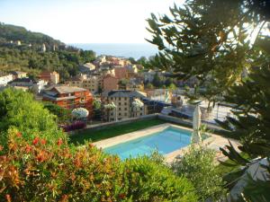 a view of a city with a swimming pool at il corbezzolo - Suite in Levanto