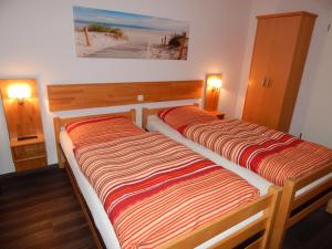 En eller flere senge i et værelse på Pension am Burgwall